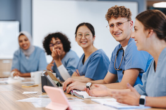 Successful medical students and researchers meeting in a university study hall