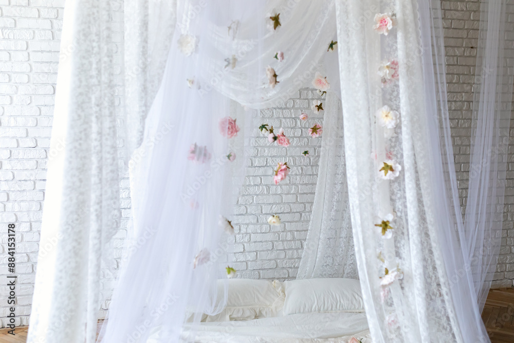 Canvas Prints Baldachin on bed. Summer pink peonies and roses flowers levitating, hanging flowers, copy space. Template, mockup. White lace curtains canopy with floral abstract pattern with spring flowers levitate	