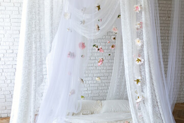 Baldachin on bed. Summer pink peonies and roses flowers levitating, hanging flowers, copy space. Template, mockup. White lace curtains canopy with floral abstract pattern with spring flowers levitate  © stock_studio
