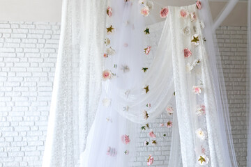 White lace texture curtains with floral abstract pattern with spring flowers levitate. Summer pink peonies flowers levitating, hanging flowers on a white background, copy space. Template, mockup.   © stock_studio