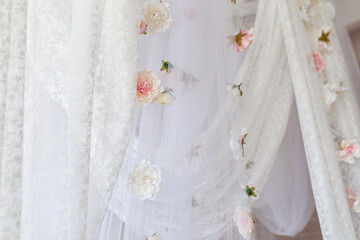 Summer pink flowers levitating, hanging flowers on a white background, copy space. Template, mockup. White elegance lace texture curtains with floral abstract pattern with spring flowers levitate  © stock_studio