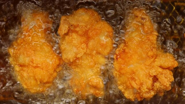 Top view of Deep fry chicken drumstick in deep-fryer. 