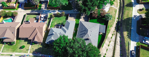 Row of large suburban houses with swimming pool, solar roof along concrete channels facilitates drainage from residential street discharge into creek in Coppell, Dallas Fort Worth complex, aerial