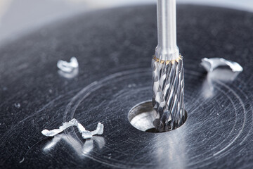 Milling cutter make sink in hole in steel billet. Locksmith work.
