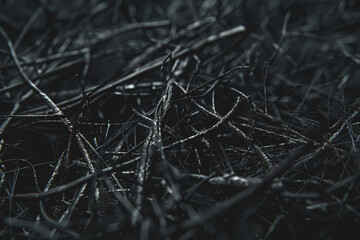 A chaotic tangle of lines forming an abstract, textured surface in dark grey and black.