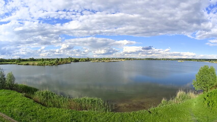 The photo shows a natural landscape - land, lakes, rivers, trees and meadow. Filming from a quadcopter.