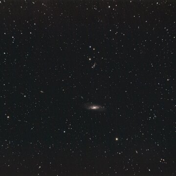 Stunning view of a distant galaxy surrounded by stars in the night sky