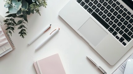 Minimalist Workspace with Laptop, Pens, and Notebook.