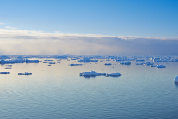 Antarctica, frozen and seascape with iceberg in ocean for cold ecosystem of environment in winter season. Earth, glacier and sky with frost on water for conservation of ecology in mother nature