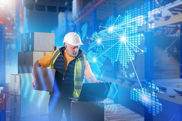 Logistics business. Man with boxes stands in warehouse. World map with supply chains. Man is...