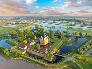 Aerial from a flooded landscape at castle Loevestein near Gorinchem in the Netherlands at sunset