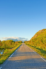 Naklejka premium Nature, road and sky with clouds by mountains, fjord and trees for transport system in summer. Landscape, mockup and space with highway, infrastructure and travel in environment by street in Norway