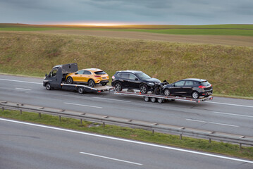 Flatbed Truck Transporting SUV Hatchbacks And Motorcycle