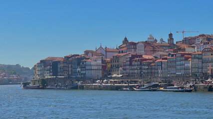 Obraz premium Porto, Portugal old town ribeira aerial promenade view with colorful houses, Douro river and boats