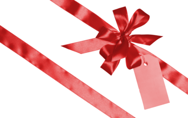 A red satin bow tied at the intersection of two ribbons. A yellow tag is attached to the bow. Isolated background