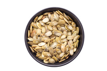 Full bowl of pumpkin seeds isolated on a white background. File contains clipping path.