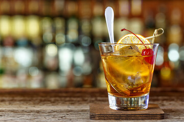 Old-fashioned cocktail garnished with cherries
