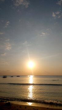 beautiful sunset at the beach with little waves
