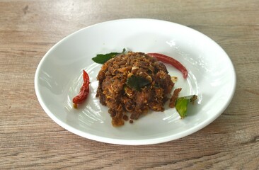 spicy fried chop fermenting fish with herb and chili on plate