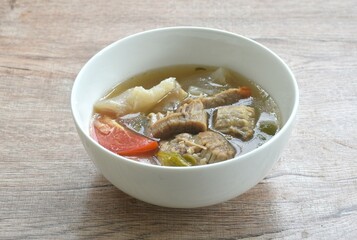 boiled braised beef meat and tendon spicy and sour tom yum soup Halal food on bowl