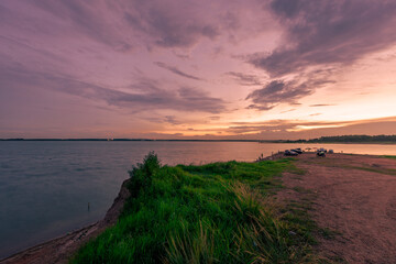 The background of the sea by the evening sea, with natural beauty (sea water, rocks, sky) and fishermen are fishing by the river bank, is a pleasure during travel.
