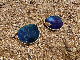 Lost Broken Sunglasses in Sand at the Beach Shore