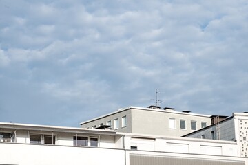 various modern buildings with flat roof and cloudy blue sky