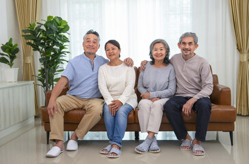 portrait senior couple, asian family sitting on sofa in the living room at home, concept of family lifestyle,relationship,domestic life