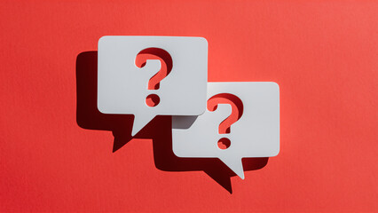 Fototapeta premium Horizontal White Speech Bubbles with Question Marks on a Bright Red Background, Representing Business Support, Investment Questions, Risk Assessment, and Confusion in Strategic Decision-Making
