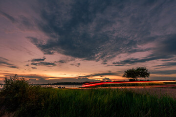 The background of the sea by the evening sea, with natural beauty (sea water, rocks, sky) and fishermen are fishing by the river bank, is a pleasure during travel.