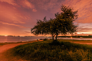The background of the sea by the evening sea, with natural beauty (sea water, rocks, sky) and fishermen are fishing by the river bank, is a pleasure during travel.