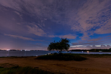 The background of the sea by the evening sea, with natural beauty (sea water, rocks, sky) and fishermen are fishing by the river bank, is a pleasure during travel.