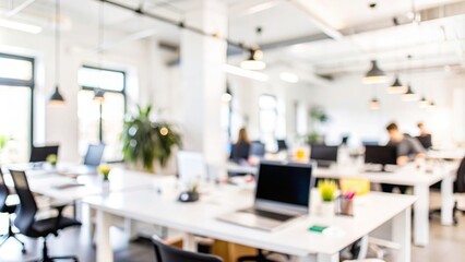 Startup Workspace Blur - A blurred workspace in a startup office with laptops and creative clutter.
