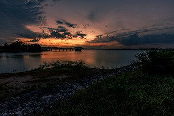 The background of the sea by the evening sea, with natural beauty (sea water, rocks, sky) and fishermen are fishing by the river bank, is a pleasure during travel.