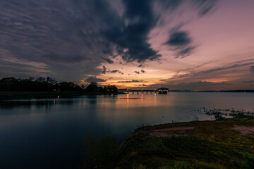 The background of the sea by the evening sea, with natural beauty (sea water, rocks, sky) and fishermen are fishing by the river bank, is a pleasure during travel.