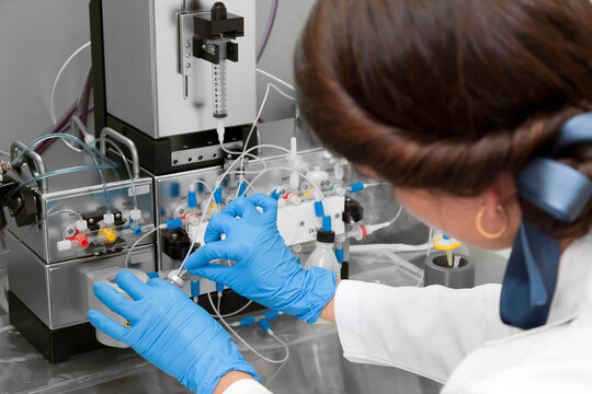 Technician preparing chemical radioactive contrast agent medicine for radiology and nuclear medicine and molecular imaging