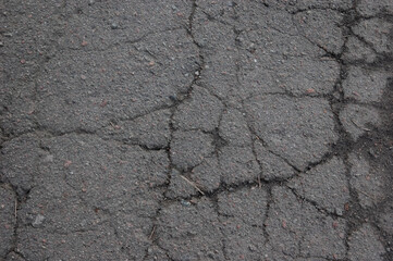 an old cracked asphalt pathway