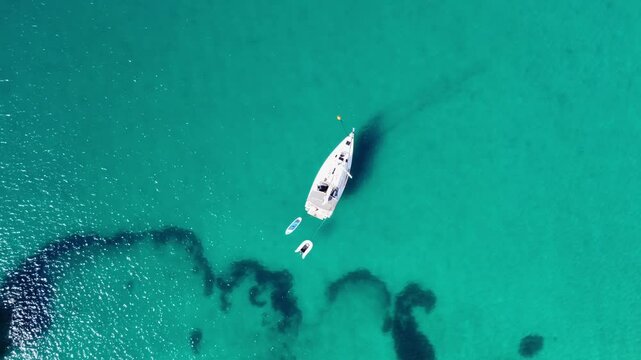 Top drone view of yachts moored on buoys near the shore in the bay of Uvala Gradina near the town of Vela Luka on the island of Korcula in Croatia