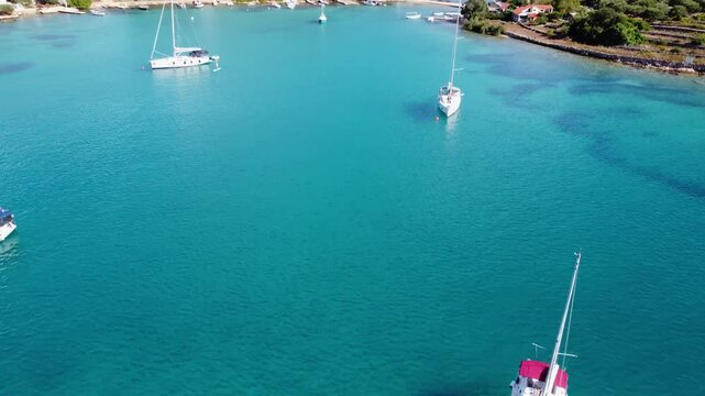 Drone view of yachts moored on buoys near the shore in the bay of Uvala Gradina near the town of Vela Luka on the island of Korcula in Croatia