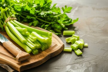 Crisp celery stalks with leaves on a cutting board, ready for cooking or snacking