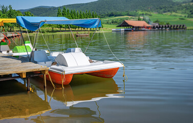 Catamarans on a pier on a picturesque lake.