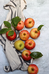 Beautiful green and red apples top view photo. Juicy organic fruit on light grey textured background with space for text. Healthy eating concept. 