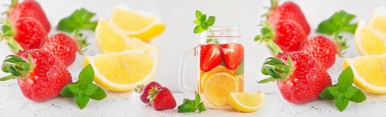 summer drink with strawberries, lemon and mint on a light background