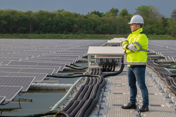 Engineer working at floating solar farm,checking and maintenance with solar batteries near solar panels,supervisor Check the system at the solar power station