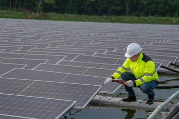 Engineer working at floating solar farm,checking and maintenance with solar batteries near solar panels,supervisor Check the system at the solar power station