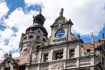 Obraz premium Town hall tower and blue illuminated clock on the facade of the new town hall in Leipzig. Latin script means, Death is certain, the hour uncertain. Building in the historicist style.