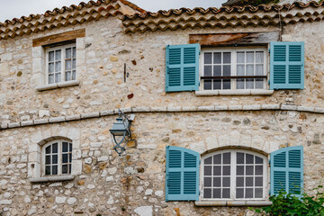 Charming Mediterranean stone house with blue shutters, rustic beauty, and traditional charm