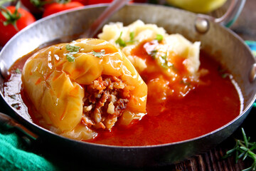 Stuffed peppers with ground meat and rice in tomato sauce
