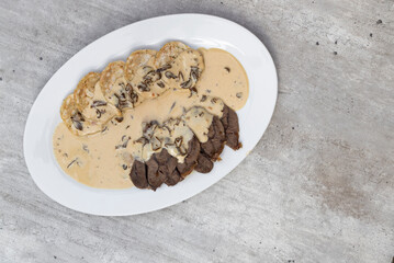 beef meat with cream mushroom sauce and karlsbad dumplings