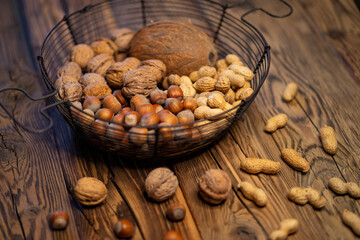 different kinds of nuts on a wooden background